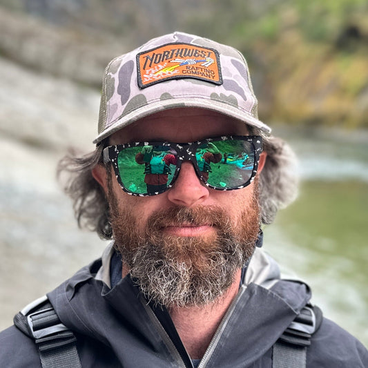 Northwest Rafting Company (NWRC) Work Hat in the Marsh Duck Camo/Loden (Green/Tan) color in action on a whitewater rafting trip